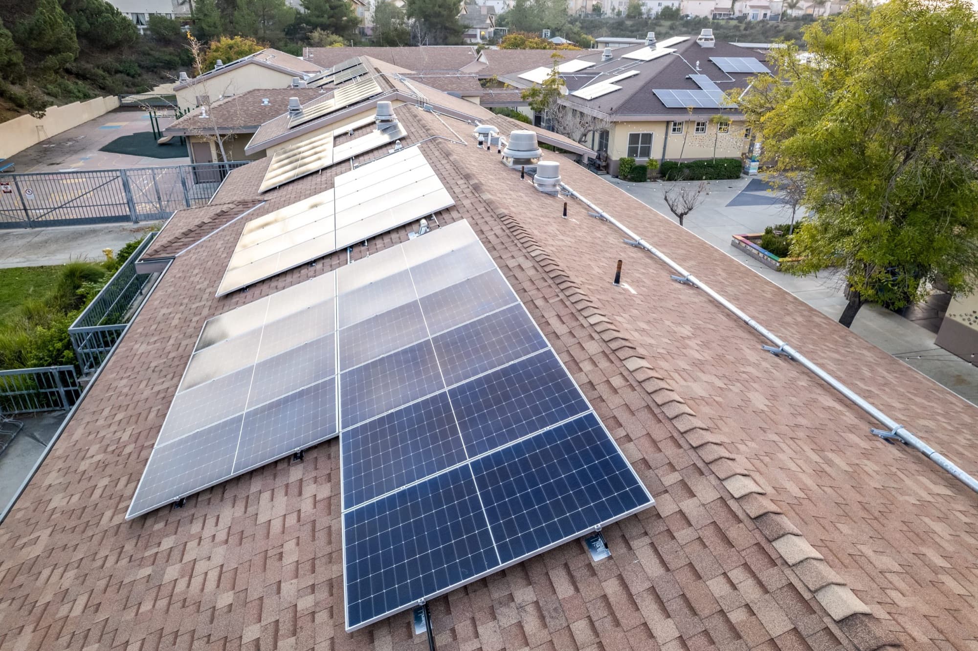 Close-up aerial of a completed solar panel array on a Spanish tile roof