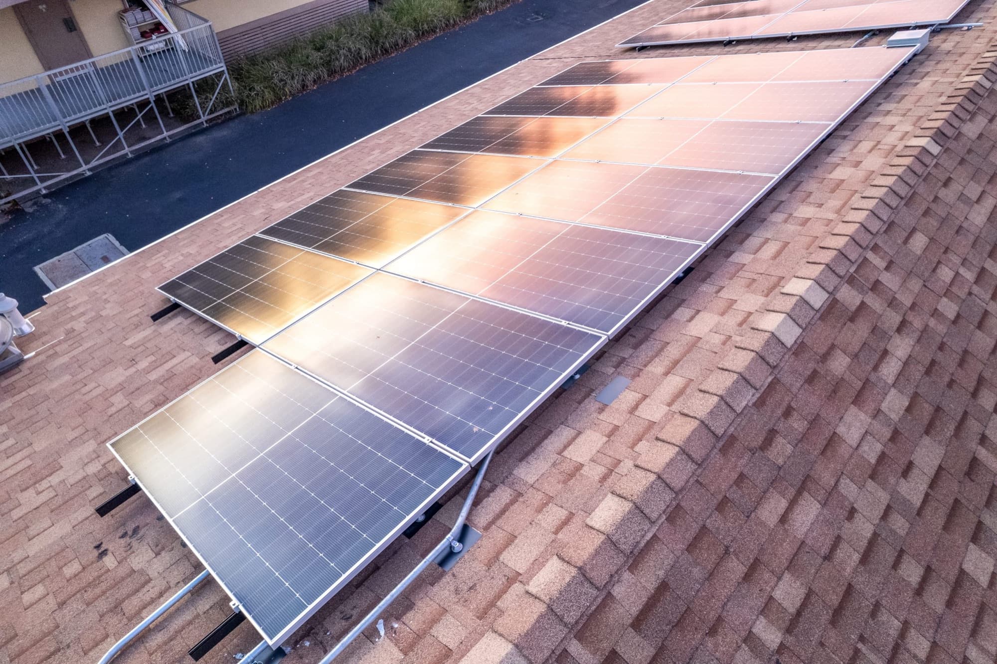 Aerial view of a completed San Diego Solar residential rooftop array at sunset